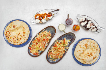 Assortiment de plats indiens – table colorée de spécialités traditionnelles. Vue du dessus d’une table garnie de plusieurs plats indiens colorés.