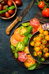 Fresh heirloom tomatoes background, organic produce at a Farmer's market. Tomatoes rainbow.