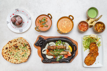 Assortiment de plats indiens – table colorée de spécialités traditionnelles. Vue du dessus d’une table garnie de plusieurs plats indiens colorés.