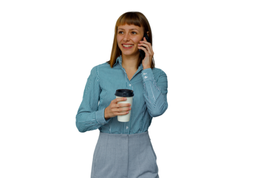Professional businesswoman multitasking, walking and talking on cellphone, holding coffee cup, smiling and communicating