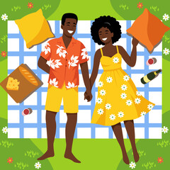Happy african american couple having summer picnic on blanket