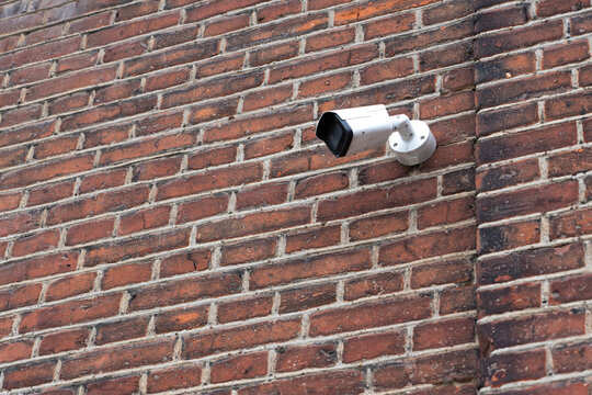 Surveillance camera on old brick wall