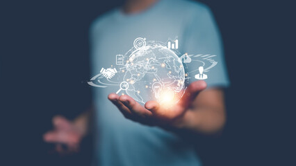 Man holding glowing digital globe with business icons, symbolizing global connection, innovation,...
