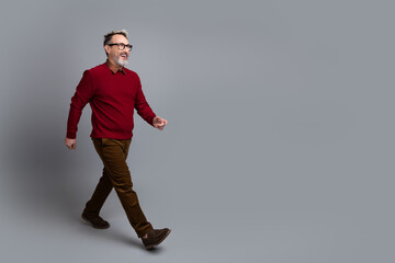 Confident mature man in casual attire walking with a smile showcasing modern lifestyle and professional outlook