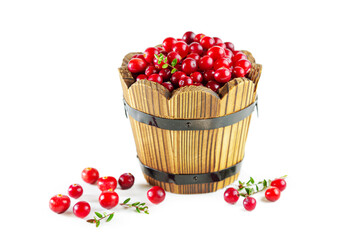 Cranberries in a wooden tub isolated on a white background.