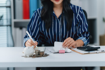 Financial Precision: A focused woman, meticulously reviewing bills and coins, embodies fiscal...