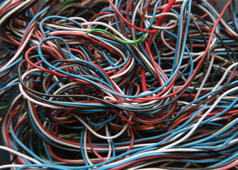 Chaotic cables on a black background. Colorful abstract thin wires texture. 
