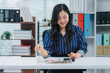 Financial Precision: An Asian professional meticulously organizes coins and bank notes at her...