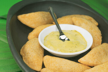 Colombian empanada with spicy sauce 