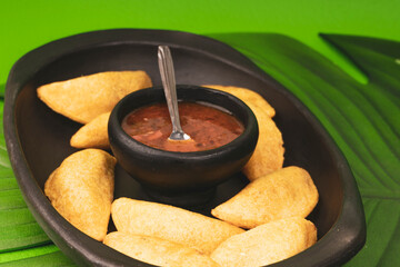 Delicious traditional Colombian empanadas with spicy sauce