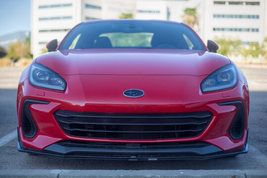 Airport City, Israel &ndash; 10.10.2025: Red Subaru BRZ Sports Car Front View with Office Buildings in the Background