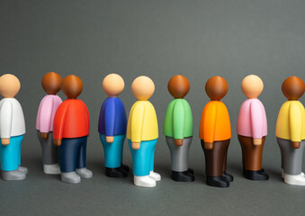 A queue of people. Figures of people stand in a queue. Bureaucracy, waiting for service, and social inequality. Public service, unemployment, or migration subjects.