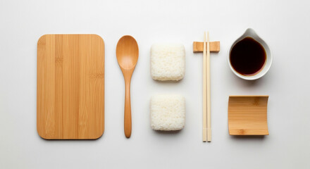 Overhead shot of sushi ingredients including rice, soy sauce, chopsticks, and a wooden cutting board