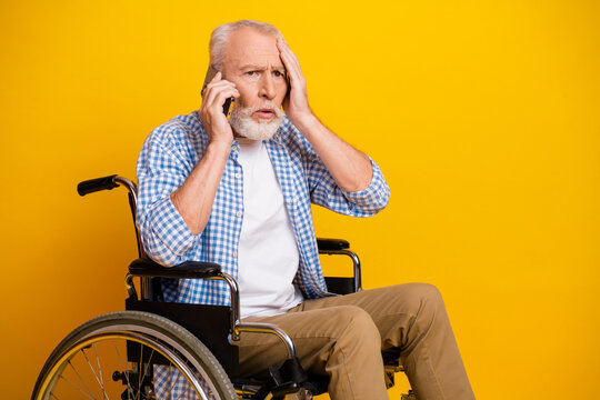 Grandpa on the phone in a wheelchair shares a funny moment of resilience and independence against a bright yellow background