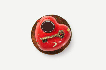 Heart-shaped red cake decorated with golden key for valentine's day or anniversary