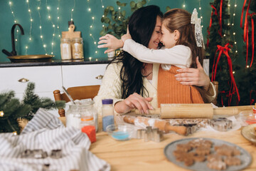 Mother and daughter baking christmas cookies together