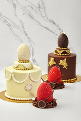 Easter cakes decorated with chocolate eggs and gold details are waiting for the celebration