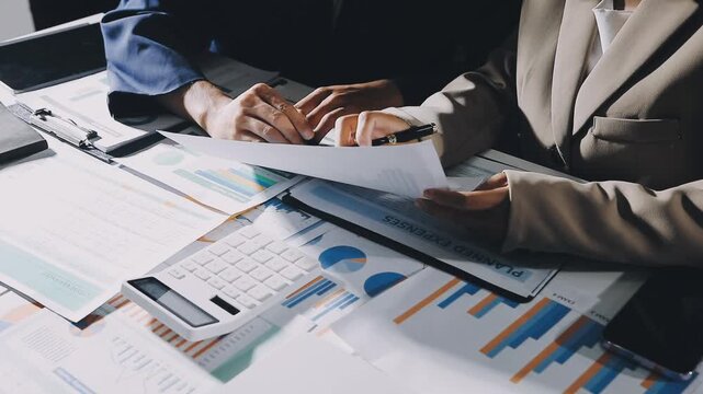 Teamwork with business people analysis cost graph on desk at meeting room