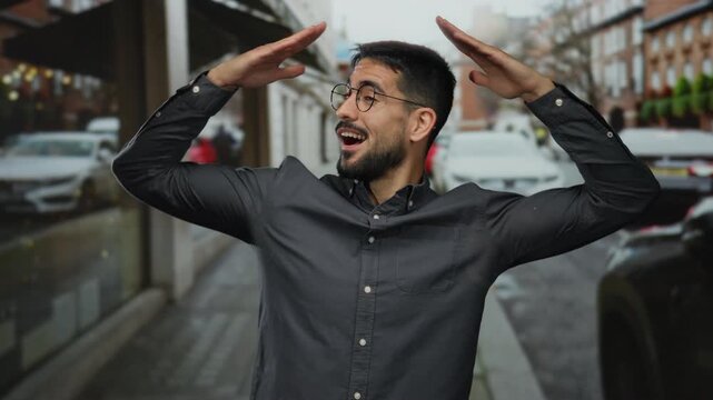 Young man in urban street setting smiling and expressing joy while surrounded by city life.