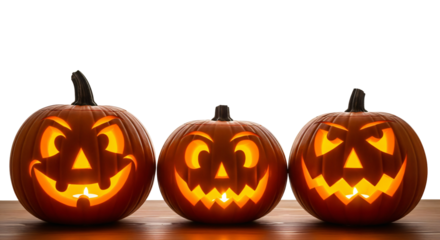 Halloween carved pumpkins, or jack-o'-lanterns on top of a woonden table. PNG no background, isolated.