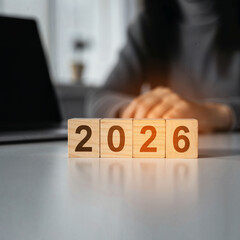 Glowing wooden blocks displaying the year 2026 in a modern office setting
