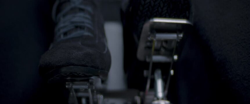 Close-up video of a race car drivers legs and feet engaging the pedals