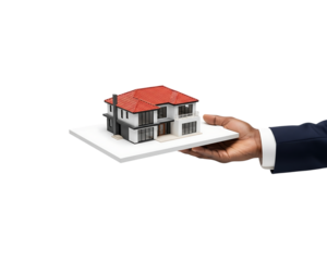 Hand holding a miniature house on a white platform isolated on transparent background
