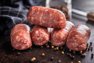 Photo of italian sausage salsiccia on black table.