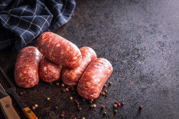 Photo of italian sausage salsiccia on black table.