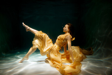 An Elegant Underwater Dance Performed Gracefully in a Flowing Yellow Gown, Captivating All