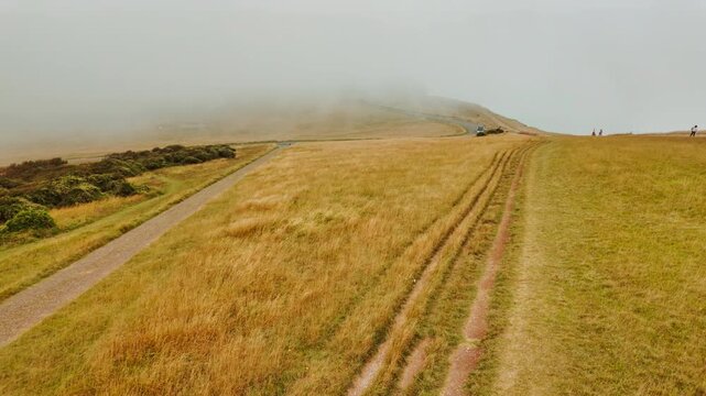 The stunning cliffs of Eastbourne enshrouded in mist, East Sussex, England, UK, with chalk faces fading into low cloud along the Channel coast