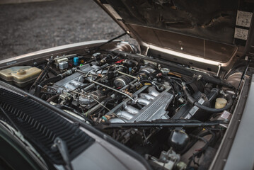 A detailed shot of the engine of a classic car, showcasing its mechanics.