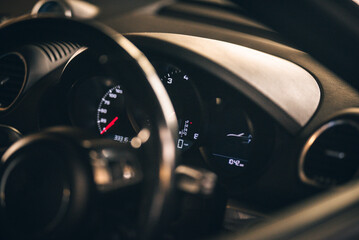 A detailed view of a car dashboard, showcasing speed and other digital readings clearly and stylishly.