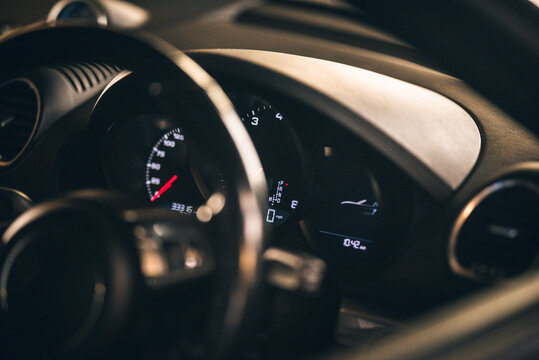 A detailed view of a car dashboard, showcasing speed and other digital readings clearly and stylishly.