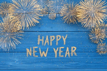 Happy New Year fireworks on blue wood background