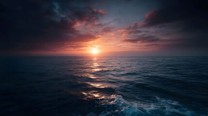 Dramatic sunset over a vast ocean with colorful clouds and shimmering reflections on the water