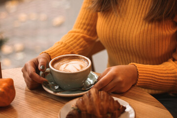 Cup of Coffee and Croissant on Cozy Autumn Morning