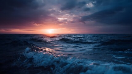 Fototapeta premium Dramatic sunset over a dark undulating ocean with atmospheric clouds
