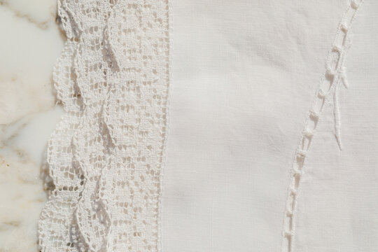 white linen lace tablecloth folded up