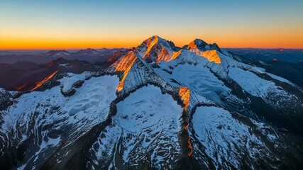 Majestic snow-capped mountain peaks bathed in golden sunrise light aerial view dramatic alpine - Powered by Adobe
