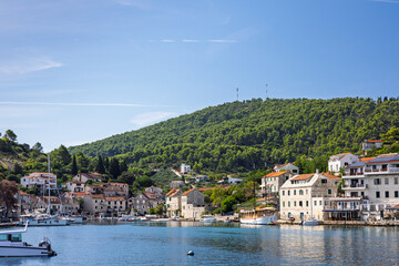 Sunny Mediterranean Harbor Town With Boats and Colorful Waterfront Homes on Clear Blue Water