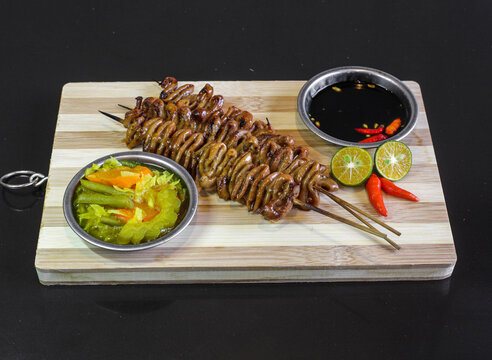 Isaw Filipino street food grilled chicken intestines on skewers