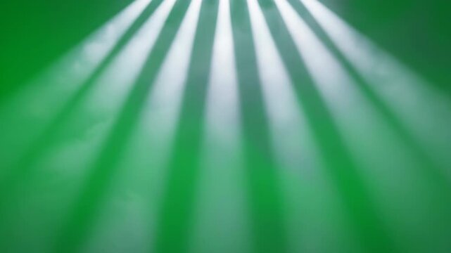 Dramatic, sharp shafts of volumetric light piercing through a smoky atmosphere against a vivid green screen vivid chroma key, overlay element, intense light