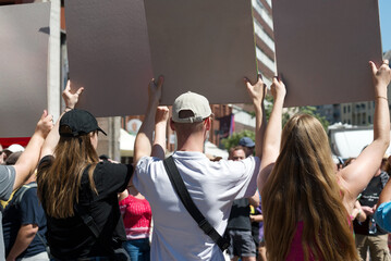 Group of protesters holding signboards on the street