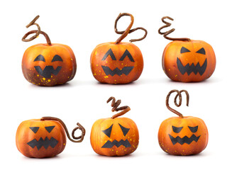 Cute Halloween pumpkins with jack-o'-lantern faces arranged in a playful group on a white background