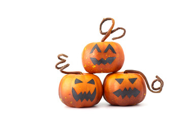 Cute Halloween pumpkins with jack-o'-lantern faces arranged in a playful group on a white background