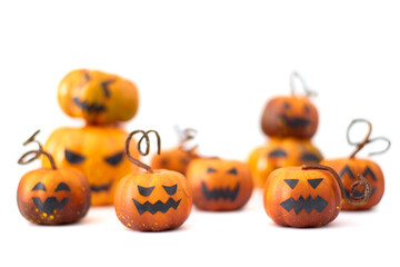 Cute Halloween pumpkins with jack-o'-lantern faces arranged in a playful group on a white background