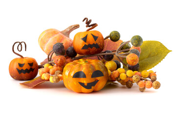 Halloween still life with small jack-o'-lantern pumpkins, pinecones, autumn leaves, and white background
