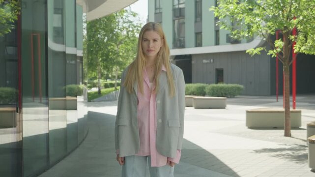 Young Blonde Woman Arguing Emotionally On Camera In Contemporary Urban Scene