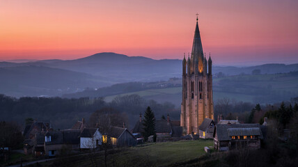 The last sunlight glints off a spire in the distance